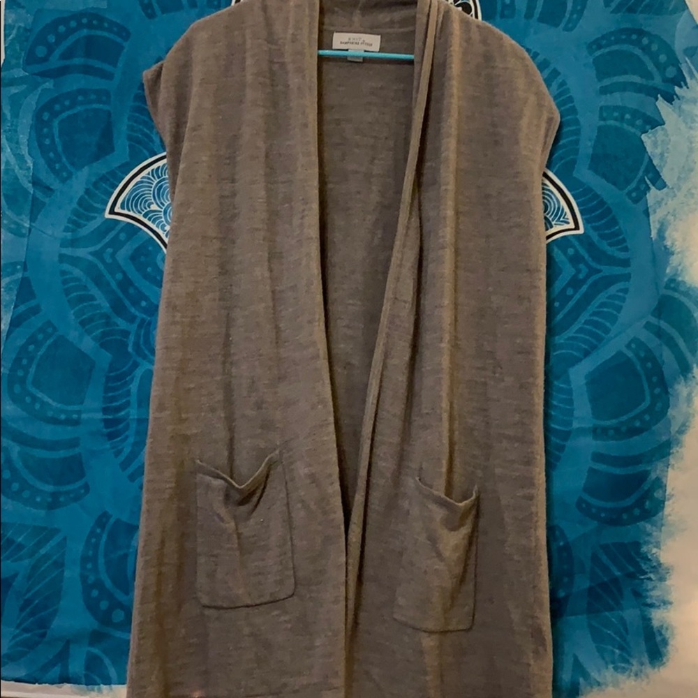 Cardigan style vest.